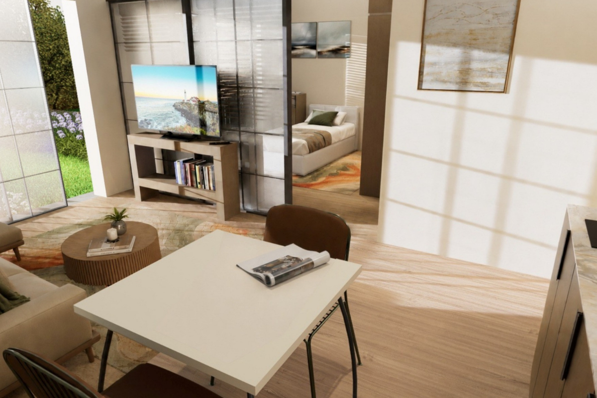 An open-plan living area featuring modern laminate flooring, a sliding glass room divider, and access to an outdoor patio space.