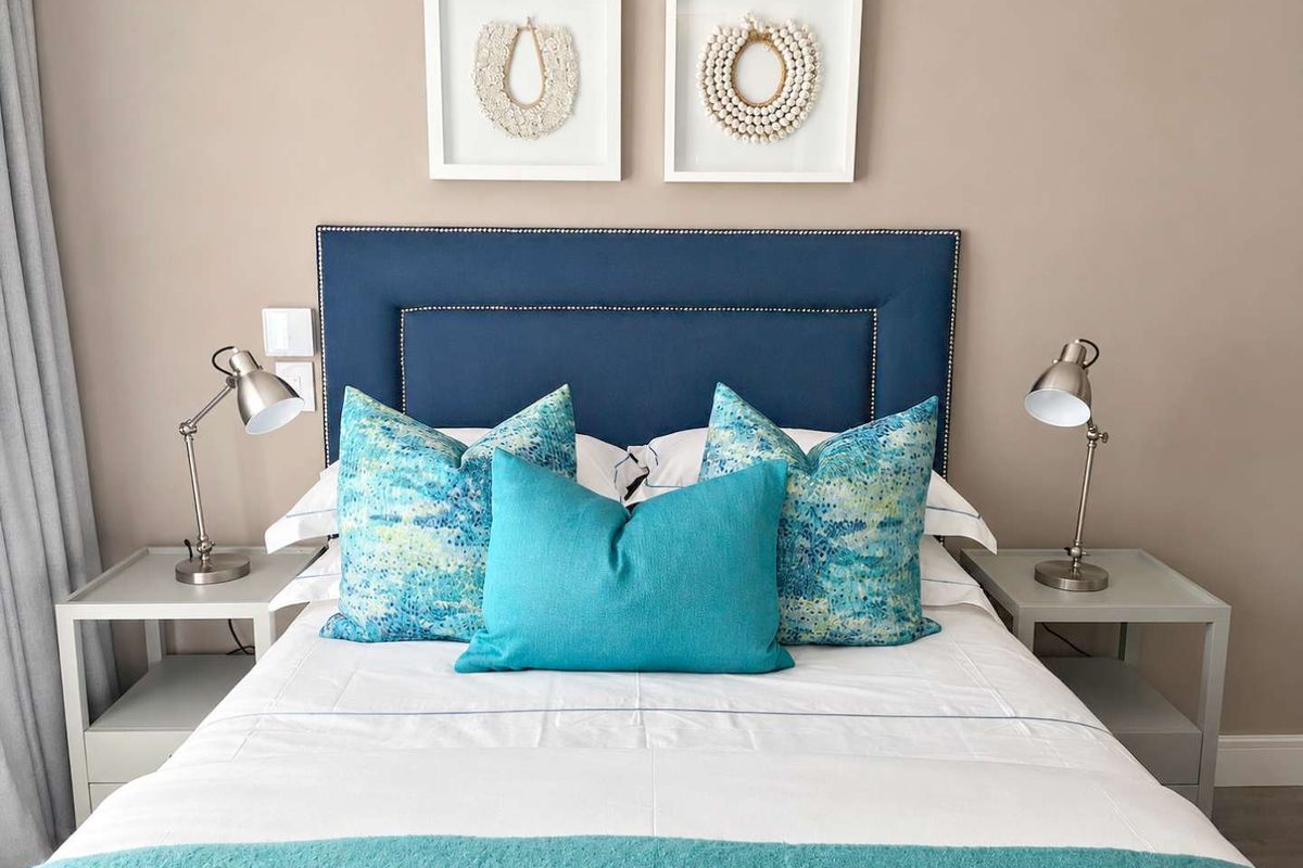 A well-maintained bedroom featuring neutral wall tones and integrated electrical fixtures.