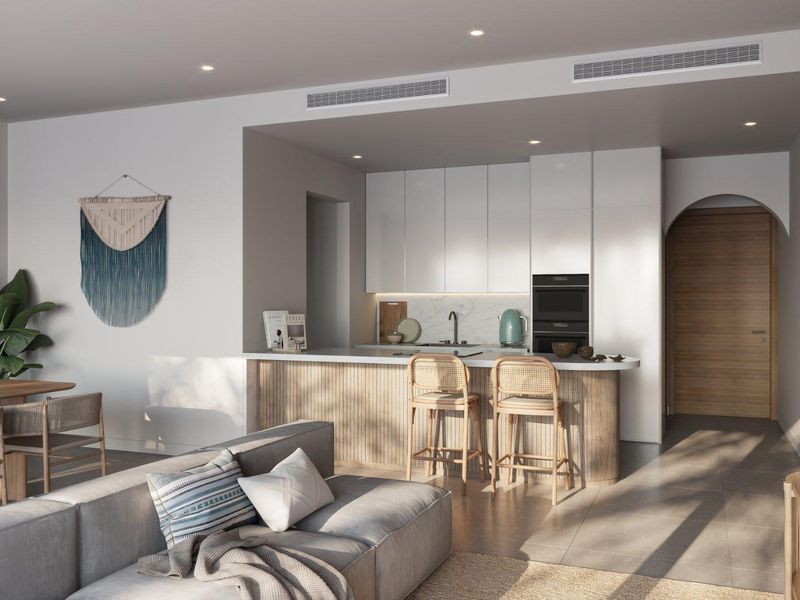 Modern open-plan living area featuring a sleek kitchen with integrated appliances, stone countertops, and a timber-slatted breakfast bar, seamlessly connected to the lounge.