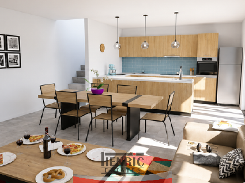 Modern open-plan living and dining area featuring a contemporary kitchen with light wood cabinetry, integrated appliances, and direct access to outdoor space.