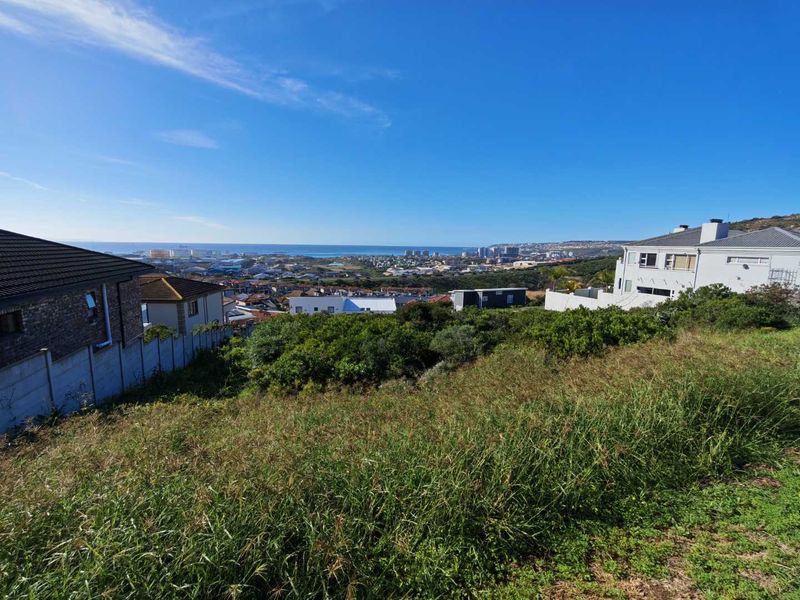 A scenic elevated view overlooking the surrounding residential neighborhood and distant coastline.