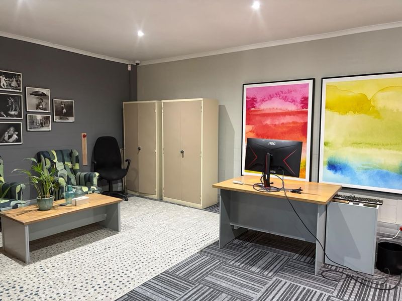 A well-maintained office space featuring recessed downlighting, durable carpet tiles, and integrated metal storage cabinets, providing a functional and professional work environment.