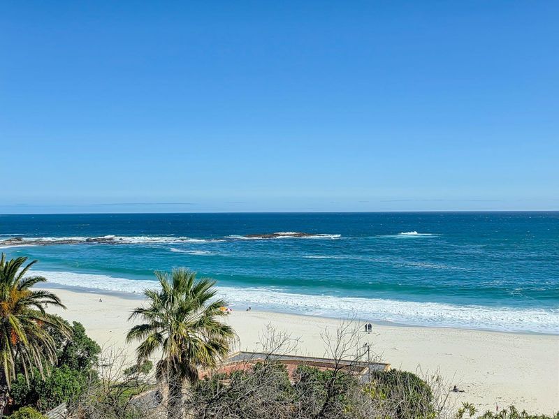 A scenic elevated view overlooking the sandy beach and the ocean.