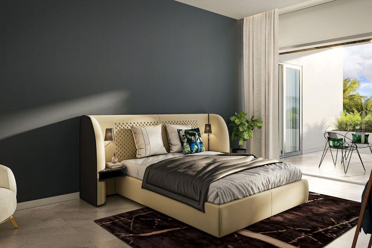 Modern bedroom featuring a dark accent wall, tiled flooring, and direct access to a private balcony through large sliding glass doors.