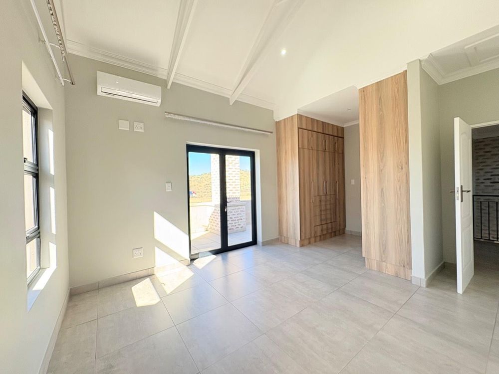 Main bedroom with doors opening onto balcony.