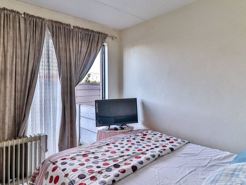 A bedroom featuring a radiator and a sliding door providing access to the exterior.
