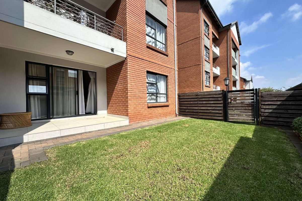A ground floor apartment featuring a private garden, paved patio area, and direct access through sliding glass doors to the living space.