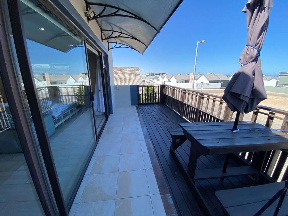 First-floor balcony with distant sea view