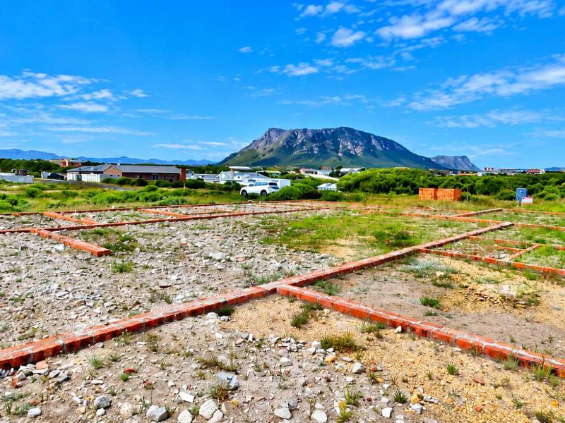 Vacant residential land featuring established brick foundation footings with scenic mountain views in the background.