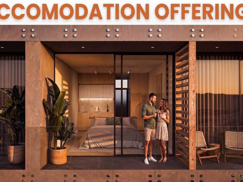 Modern open-plan hotel suite featuring a seamless transition between the bedroom area and a private balcony with contemporary timber and glass finishes.