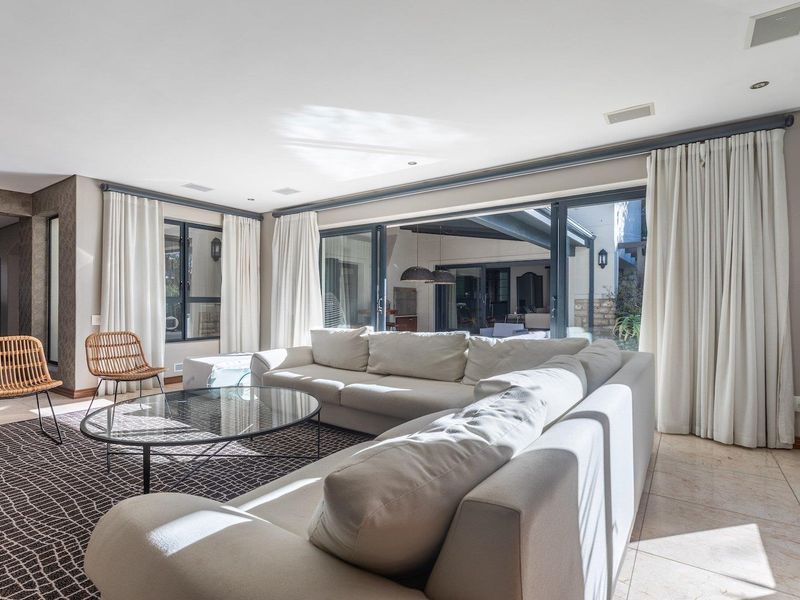 Spacious living room featuring large sliding glass doors that provide seamless access to the outdoor patio area and abundant natural light.