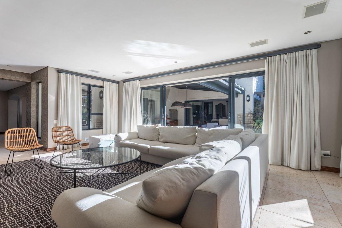 Spacious living room featuring large sliding glass doors that provide seamless access to the outdoor patio area and abundant natural light.