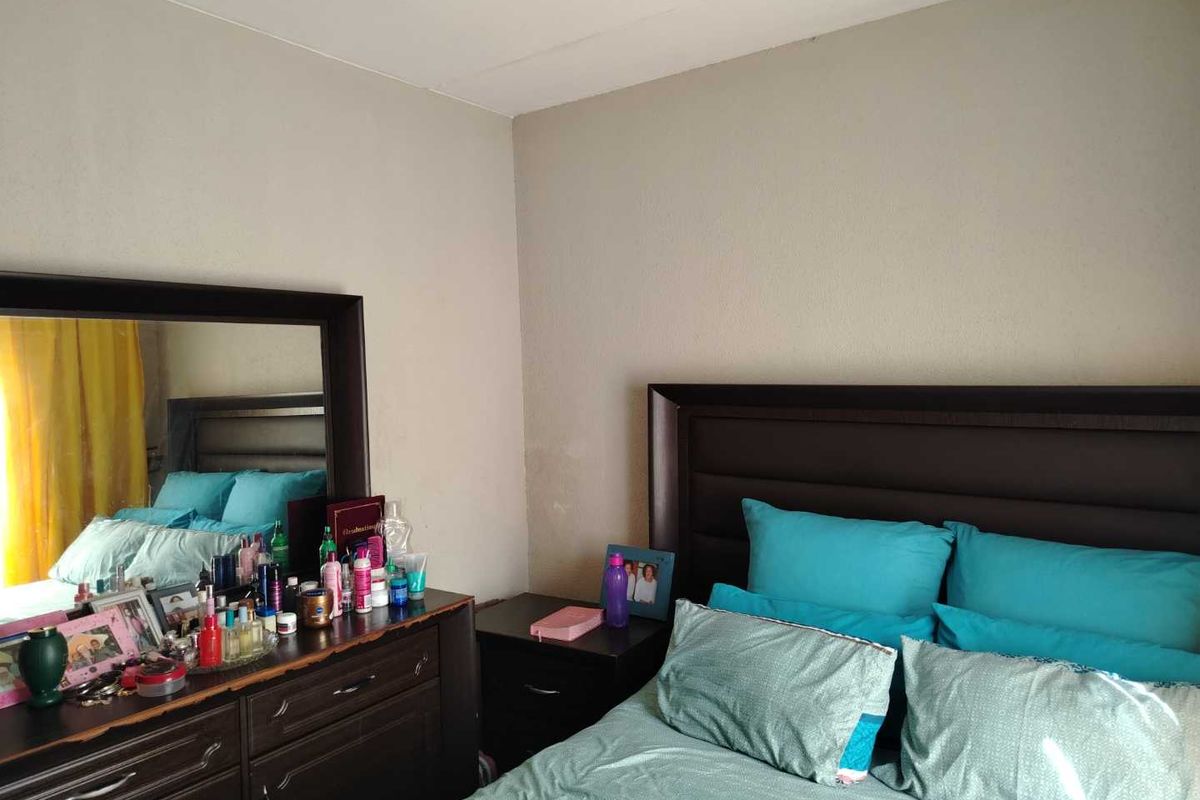 A bedroom featuring neutral wall finishes and a standard layout, providing a functional space for rest.
