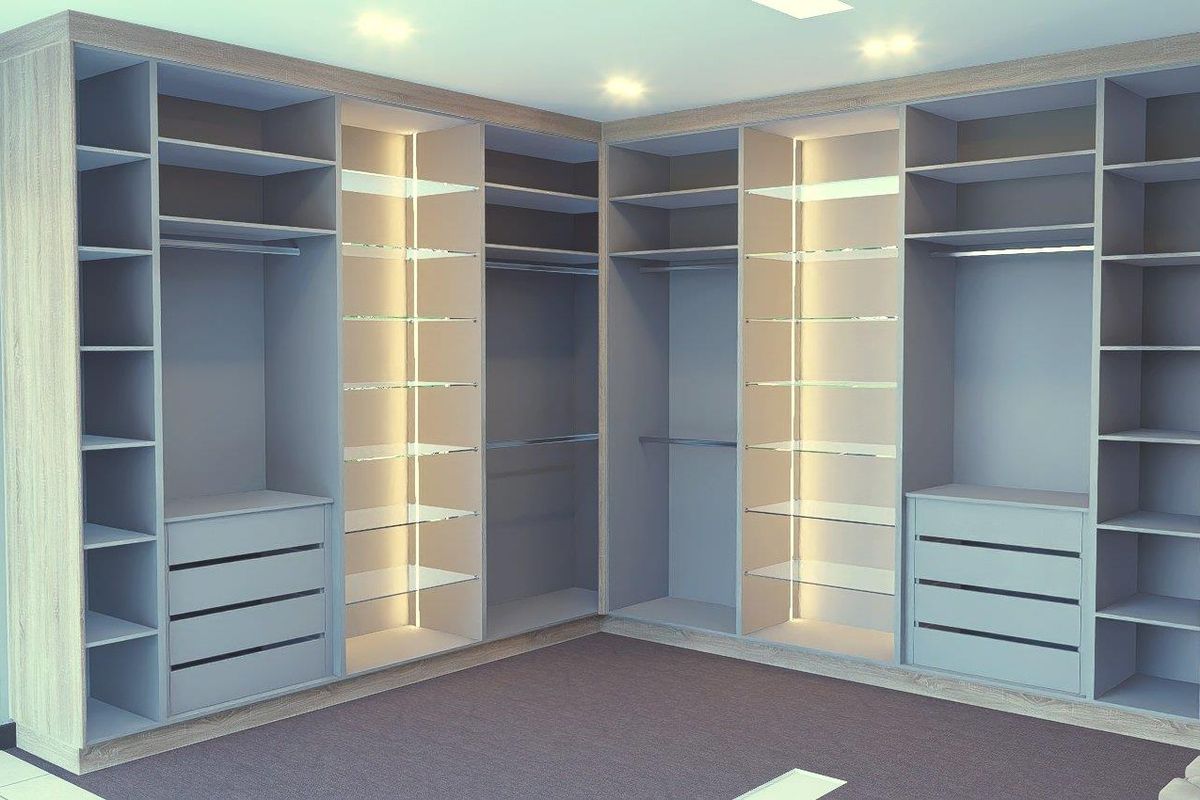 A modern walk-in closet featuring extensive custom built-in cabinetry with integrated LED lighting, shelving, and hanging rails.