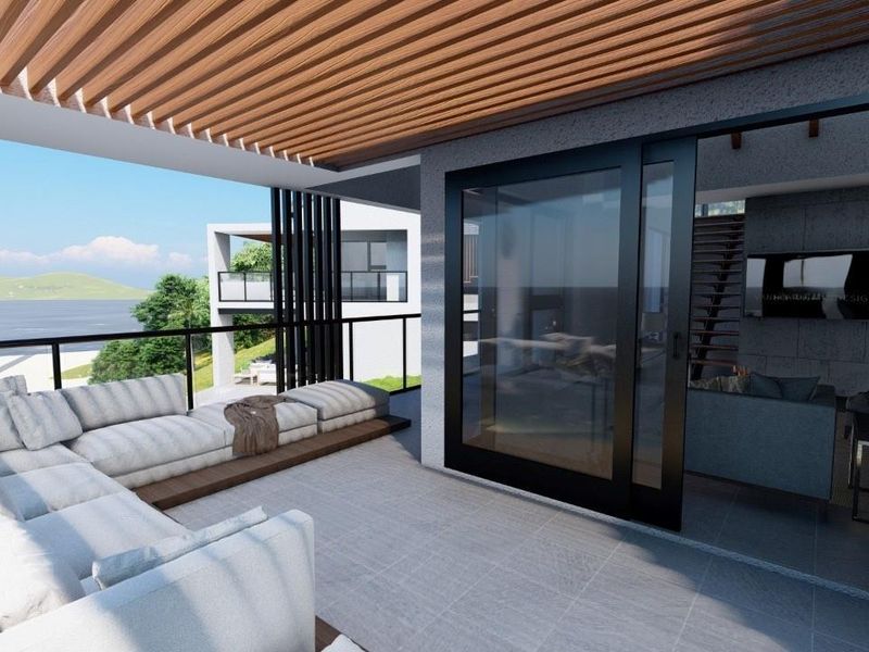 Modern covered balcony featuring a timber slat ceiling, tiled flooring, and large sliding glass doors providing seamless indoor-outdoor flow.