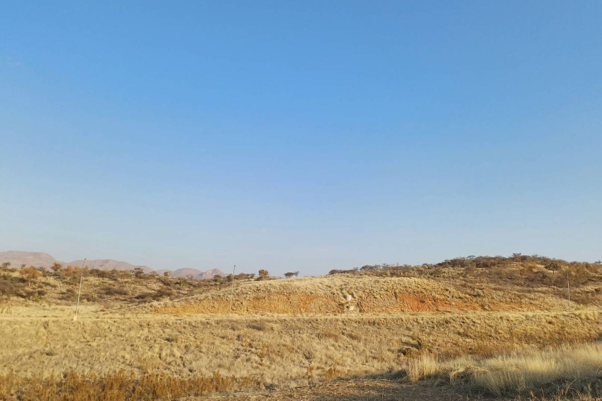 A scenic view of the natural hilly landscape and open terrain surrounding the vacant residential property.