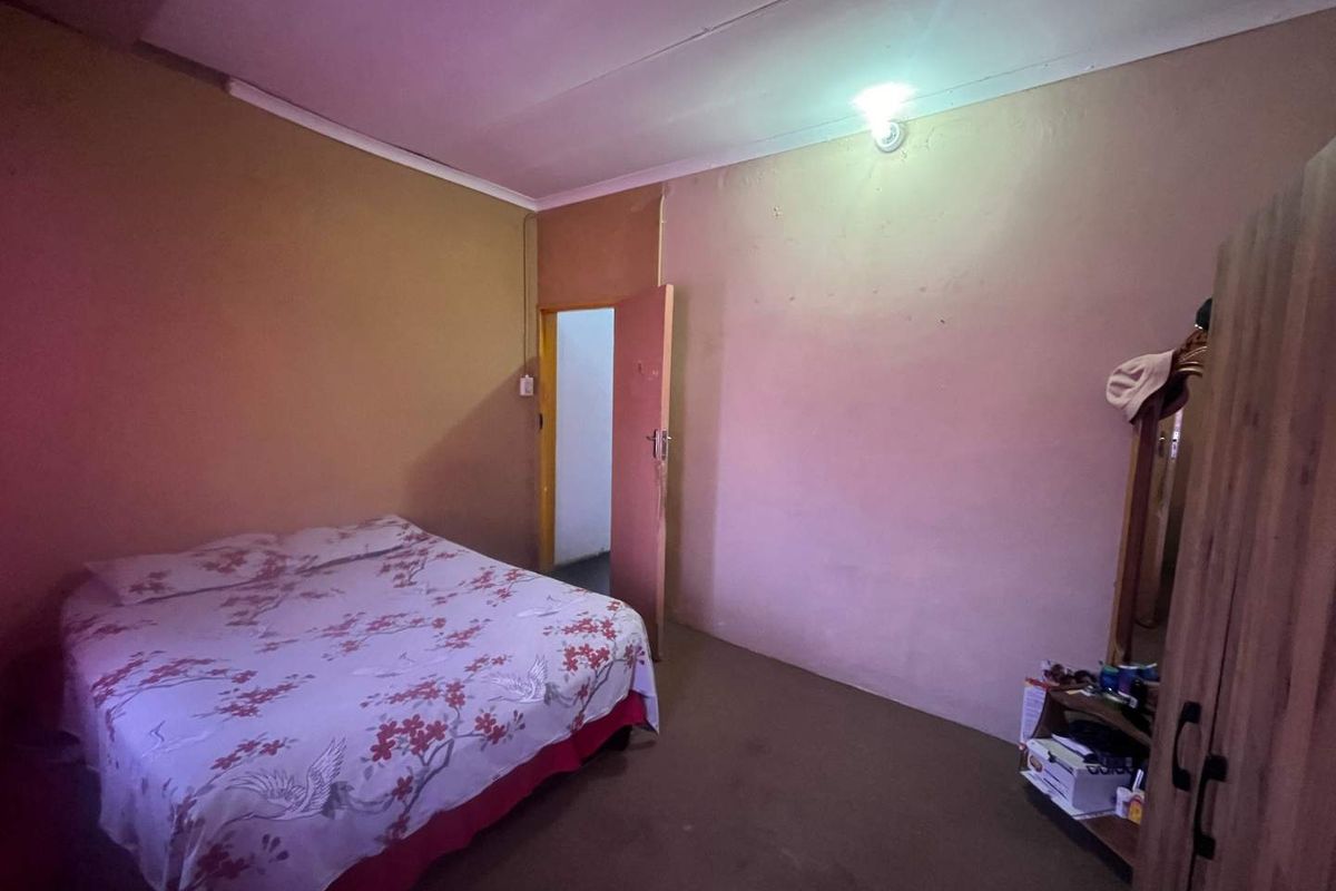 A simple bedroom featuring plain walls and a standard internal door, requiring cosmetic updates to improve the overall aesthetic and finish.