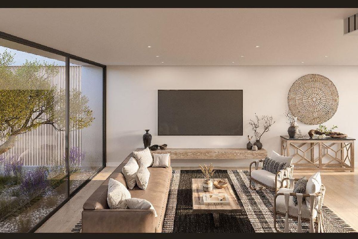 Modern open-plan living area featuring large floor-to-ceiling sliding glass doors overlooking a private courtyard, recessed lighting, and a sleek floating media console.