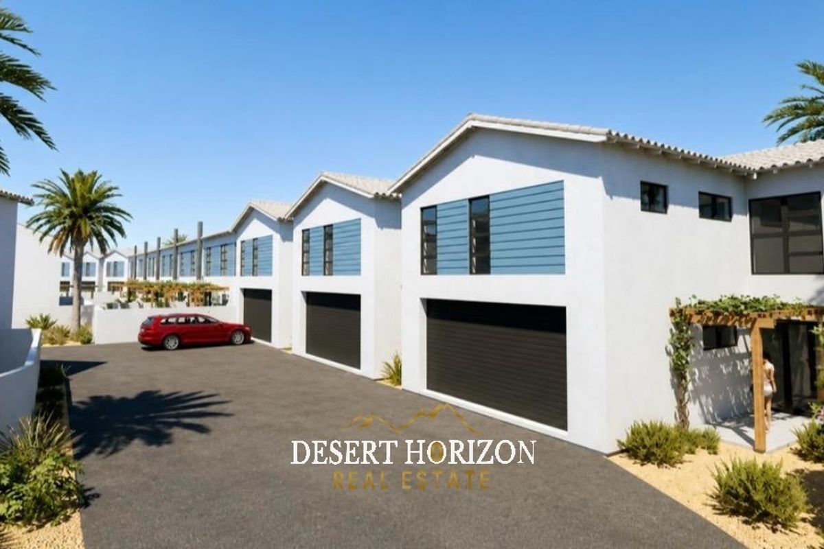 A modern townhouse complex featuring a paved driveway, multiple garage access points, and timber pergola detailing on the exterior facade.