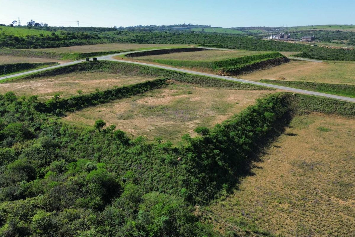 Aerial view of a large, terraced industrial land parcel featuring established access roads and cleared development platforms.