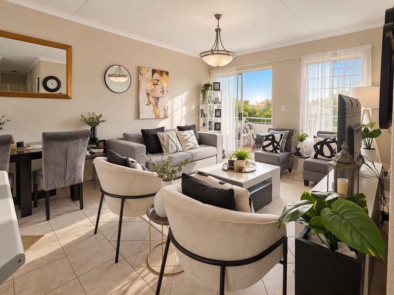 Bright open-plan living and dining area featuring tiled flooring, neutral walls, and a sliding glass door providing access to the balcony.