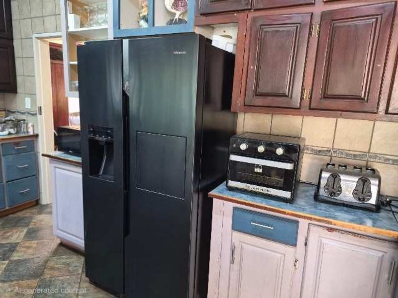 A dated kitchen featuring dark wood upper cabinetry, tiled backsplash, and tiled flooring, offering potential for a modern renovation.