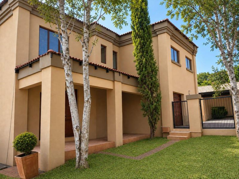A well-maintained two-story residential property featuring a covered patio, terracotta roof tiles, and a landscaped front garden with paved access.