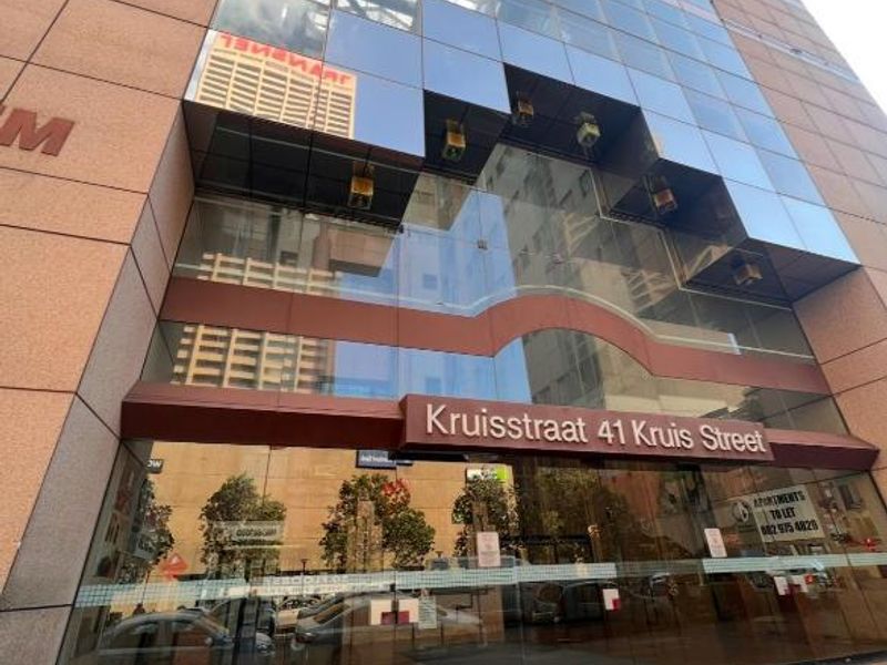 Exterior view of the modern glass-fronted apartment building entrance located at 41 Kruis Street.