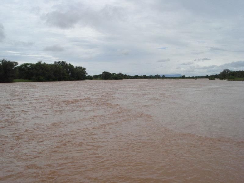 A wide view of a large, flowing river landscape, showcasing the natural surroundings of the property.