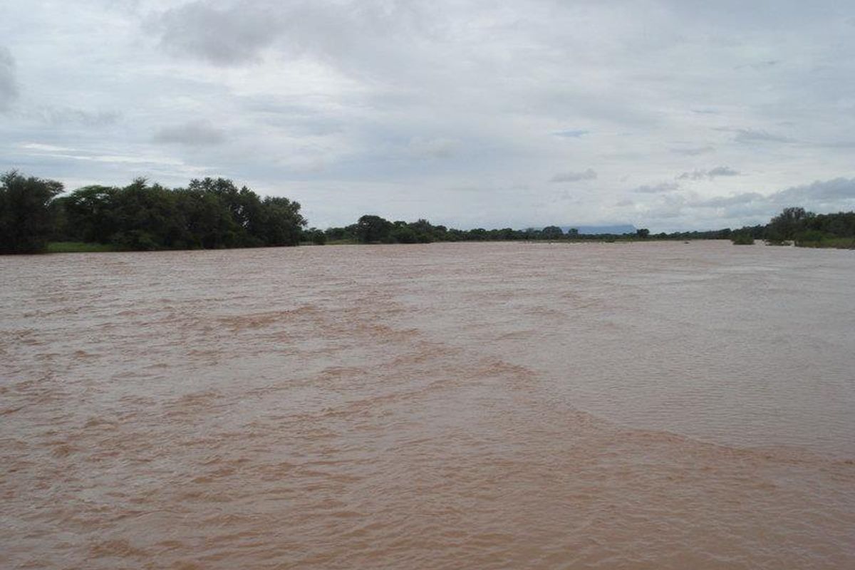 A wide view of a large, flowing river landscape, showcasing the natural surroundings of the property.