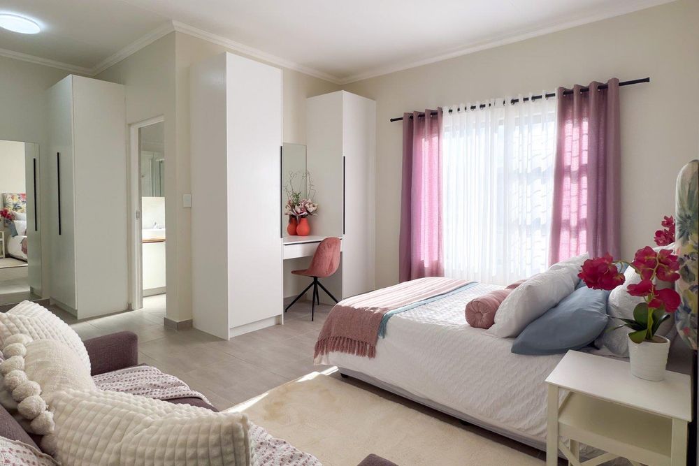Large main bedroom with built-in cupboards, a dressing room and ensuite bathroom.