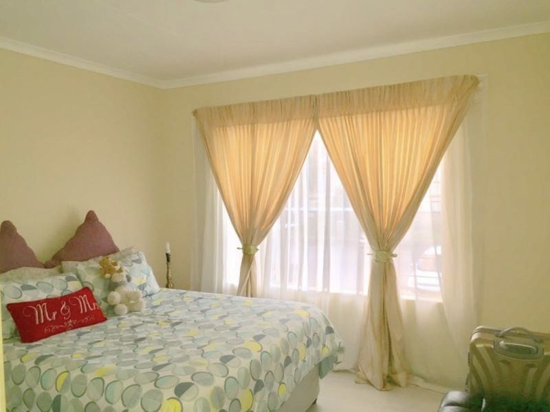 A bedroom featuring neutral wall finishes and window treatments, providing a blank canvas for potential interior design updates.