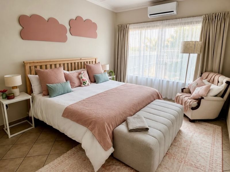 A well-maintained bedroom featuring tiled flooring, a wall-mounted air conditioning unit, and neutral wall finishes.