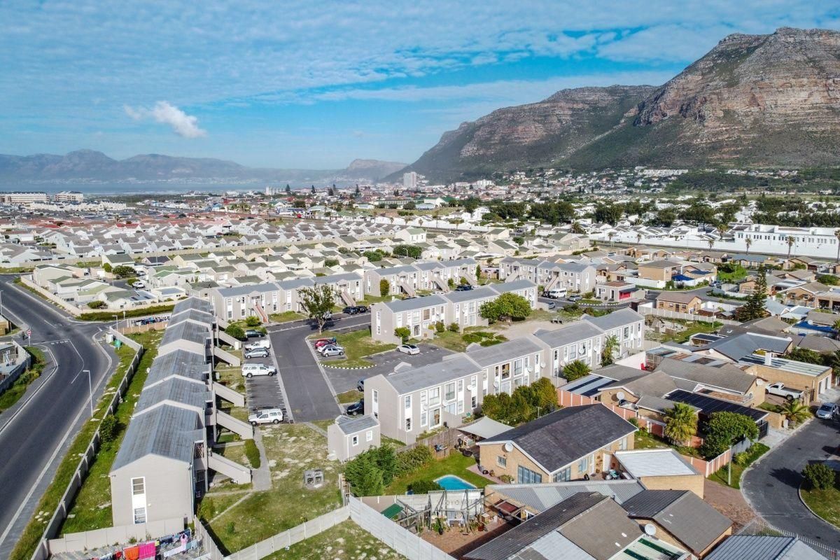 Aerial view of a residential apartment complex and surrounding neighborhood, showcasing the property layout, street access, and proximity to local infrastructure.