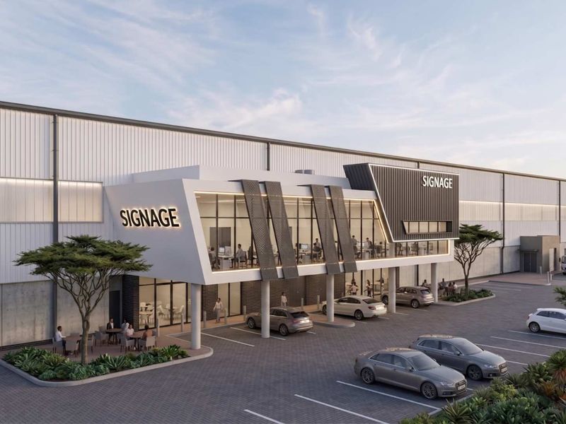 Modern industrial facility featuring a contemporary architectural facade with extensive glazing, integrated signage, and a paved parking area.