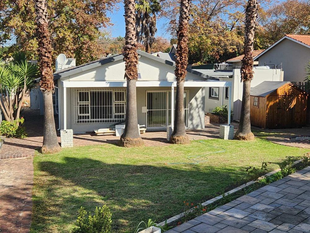 View from pool to back yard, patio and house