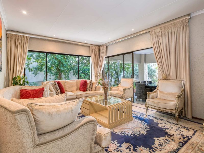 Spacious living room featuring large sliding glass doors that provide abundant natural light and seamless access to the outdoor patio area.