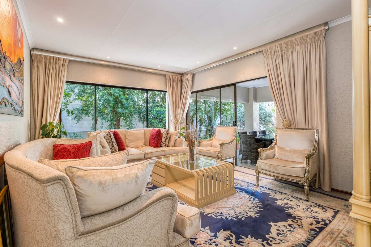 Spacious living room featuring large sliding glass doors that provide abundant natural light and seamless access to the outdoor patio area.