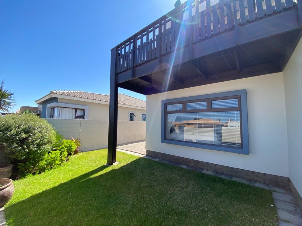 Front of the house and the first-floor balcony from the kitchen