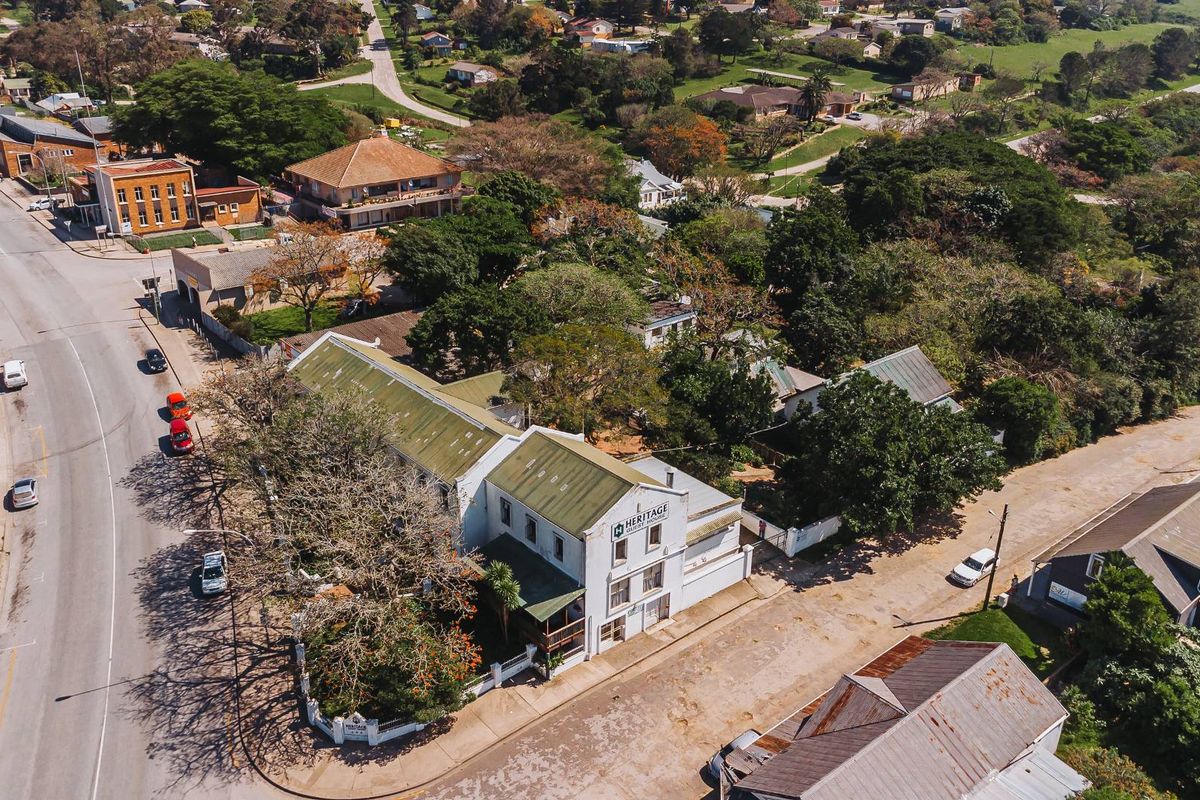 Aerial view of the property showing the building structure, roof profile, and surrounding street layout in a commercial setting.