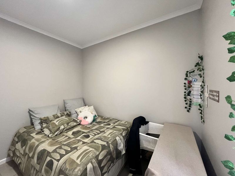 A standard bedroom featuring neutral wall paint and ceiling coving, providing a blank canvas for personalization.