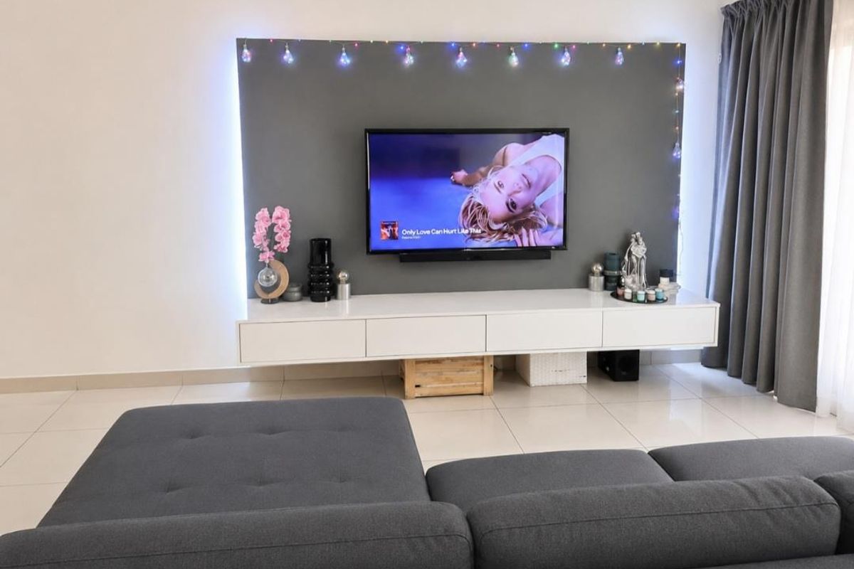 A modern living room featuring a sleek, wall-mounted media console and a dedicated feature wall with integrated lighting.