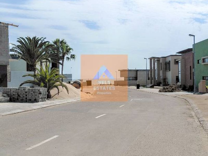 A street view showing the paved road and surrounding residential development within the estate.