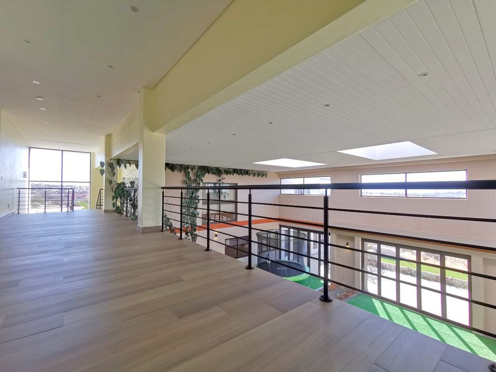 TOP FLOOR LOOKING DOWN TO THE INDOOR GARDEN WITH POOL