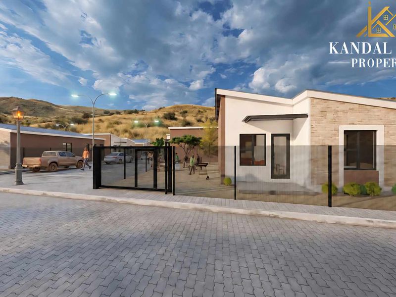 A modern townhouse exterior featuring stone cladding, a paved driveway, and secure gated access within a well-planned residential development.