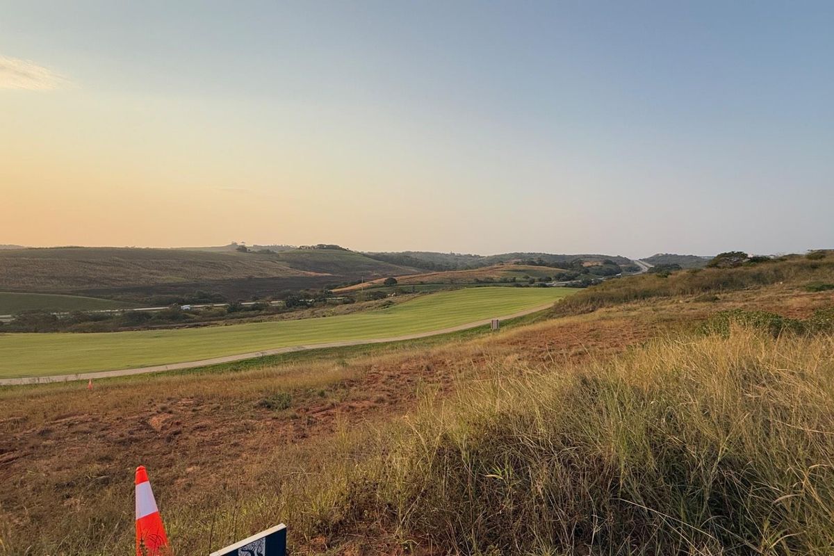 A wide-angle view of the vacant residential land, showcasing the natural topography and surrounding landscape.