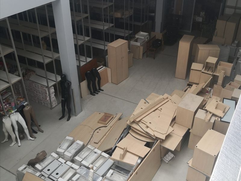 Spacious industrial utility area featuring a mezzanine level, metal shelving units, and durable concrete flooring, suitable for storage or warehouse operations.