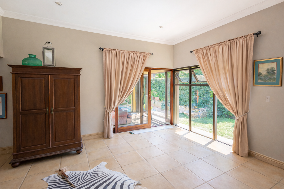 Bright living area featuring large sliding glass doors that provide seamless access to the outdoor patio and garden space.