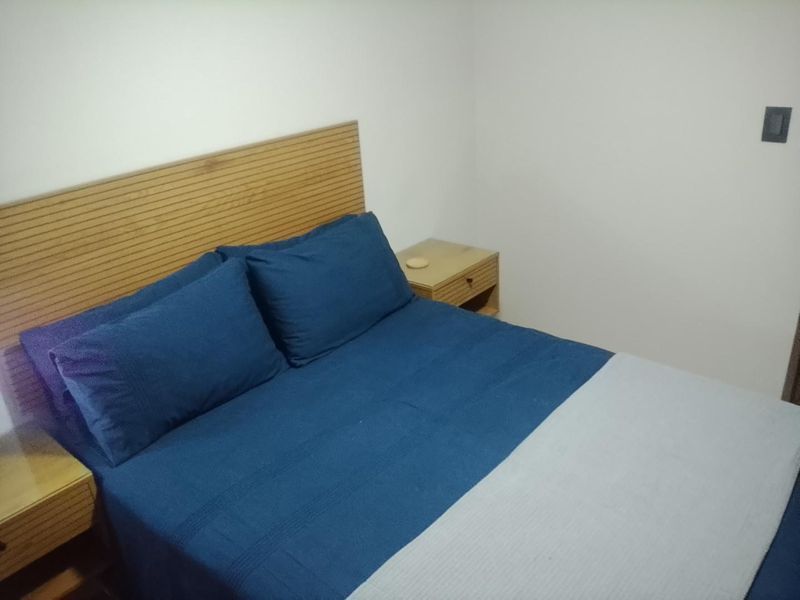 A simple bedroom featuring neutral walls and a functional layout, suitable for personalization.