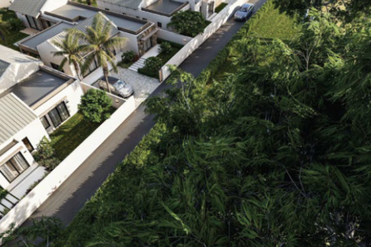An aerial view of a modern residential estate featuring paved driveways, landscaped gardens, and contemporary homes with metal roofing.